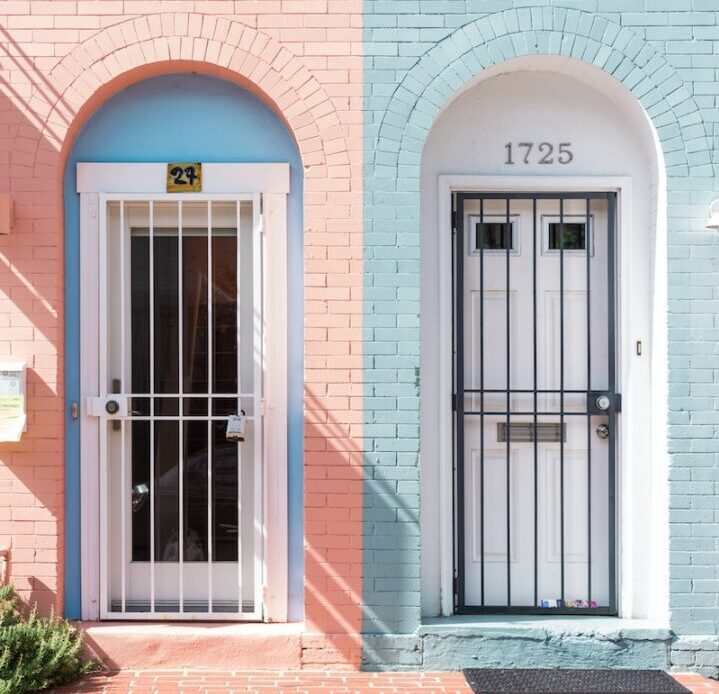 two white wooden doors with grills