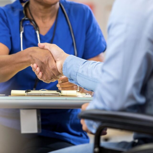 doctor shaking hands with a patient