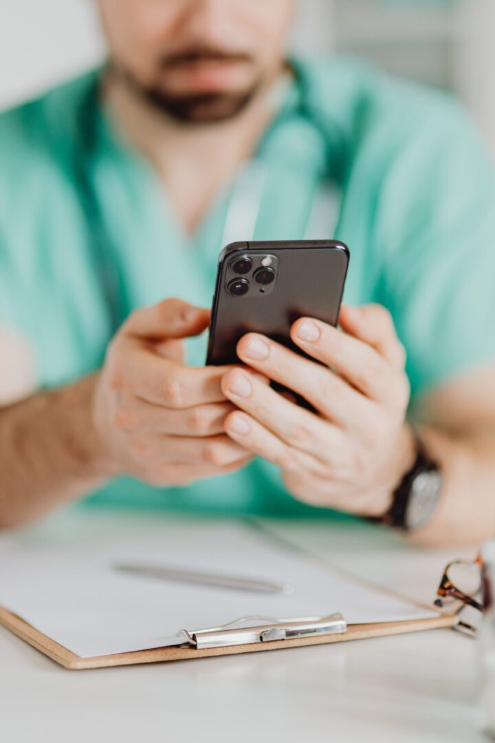 Social Media Engagement for Functional Medicine Clinics 1 male medicine doctor holding mobile phone scaled